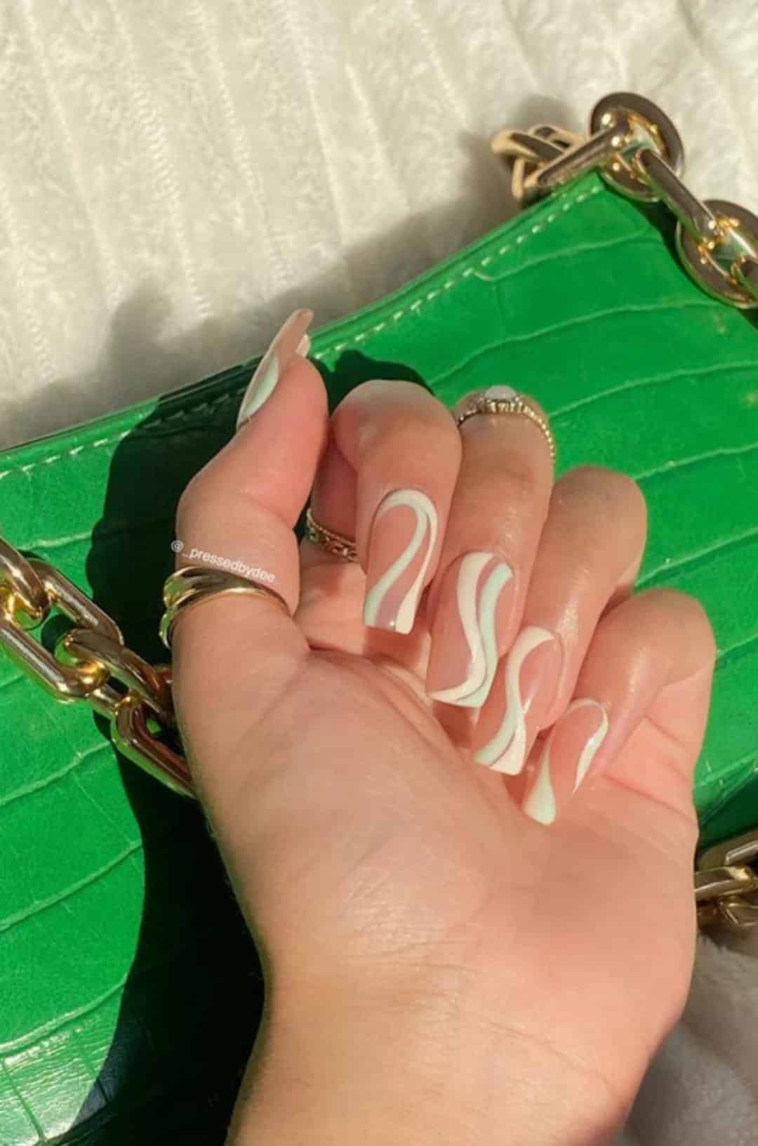 Sage green nails with swirls